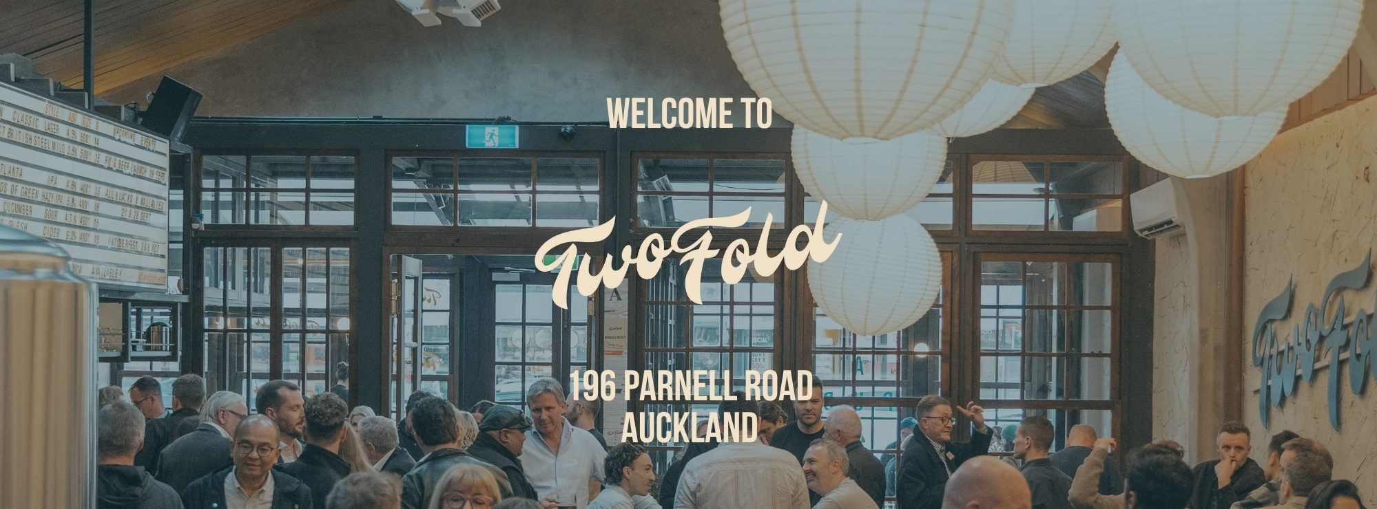 A group of people sharing food and beverage at Twofold 